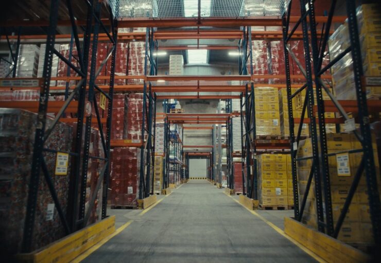 Industrial warehouse with stacked pallets ready for wholesale distribution across multiple retail channels