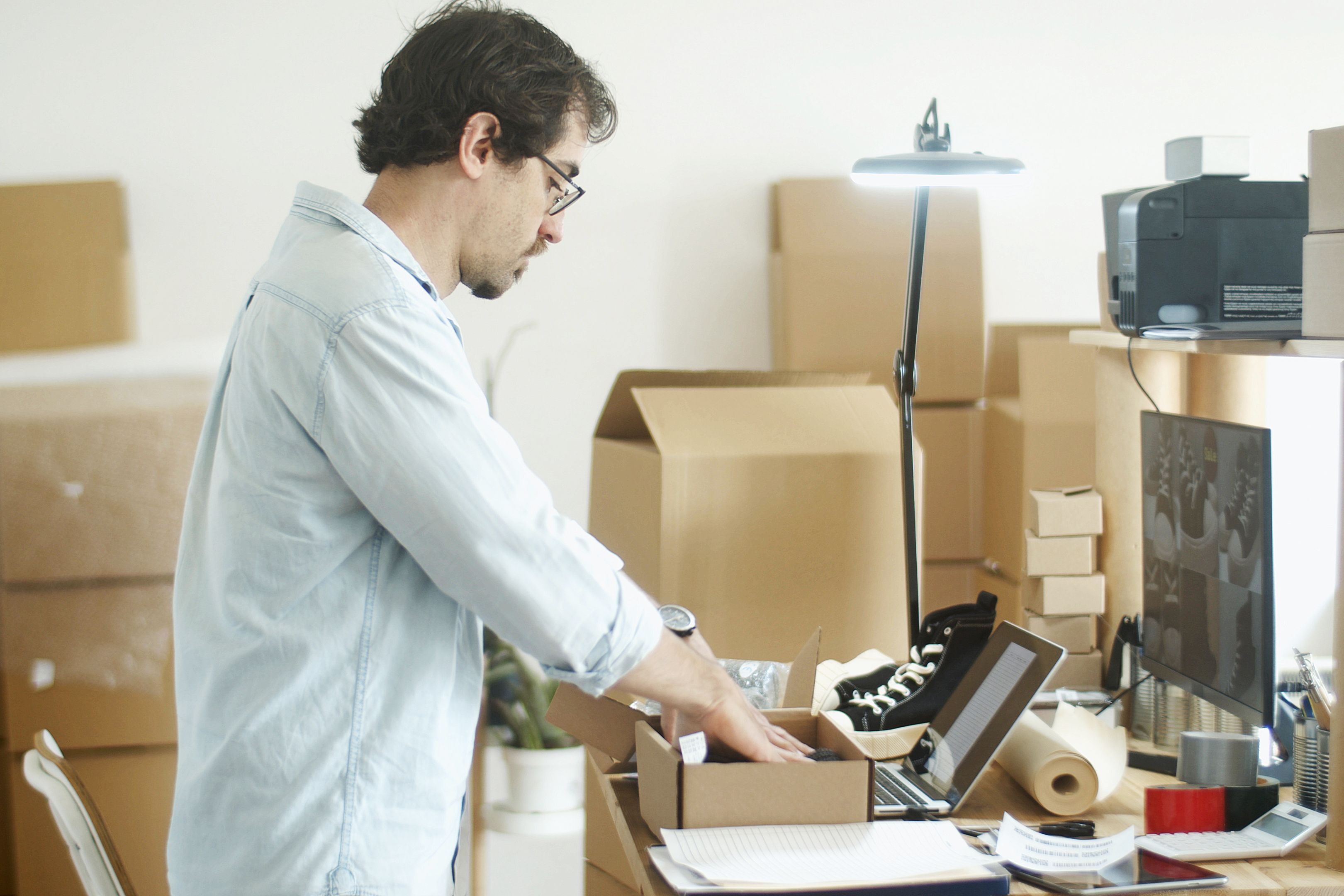 Small business owner packing products for an online store in a home office